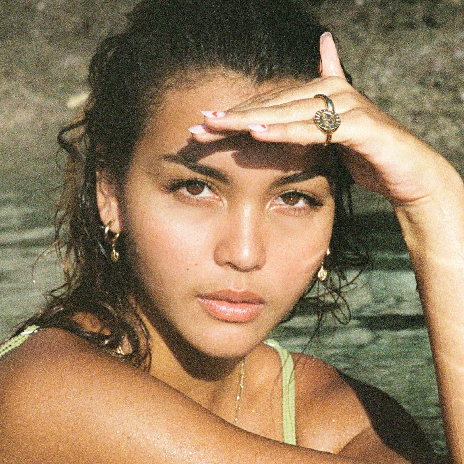 @caitlinnorthlewis wearing the gold sun ring