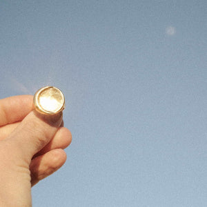 gold moon ring with sun's reflection